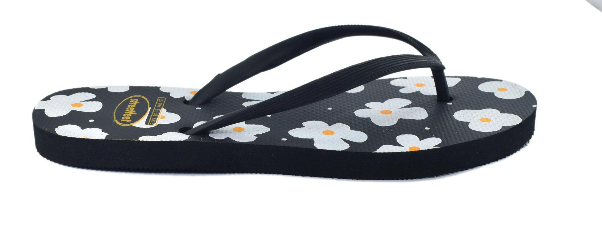Street Feet's Flower Design Flip-Flops in black sole and white flowers, featuring soft soles and durable rubber straps for maximum comfort. Lightweight and breathable, ideal for casual wear.
