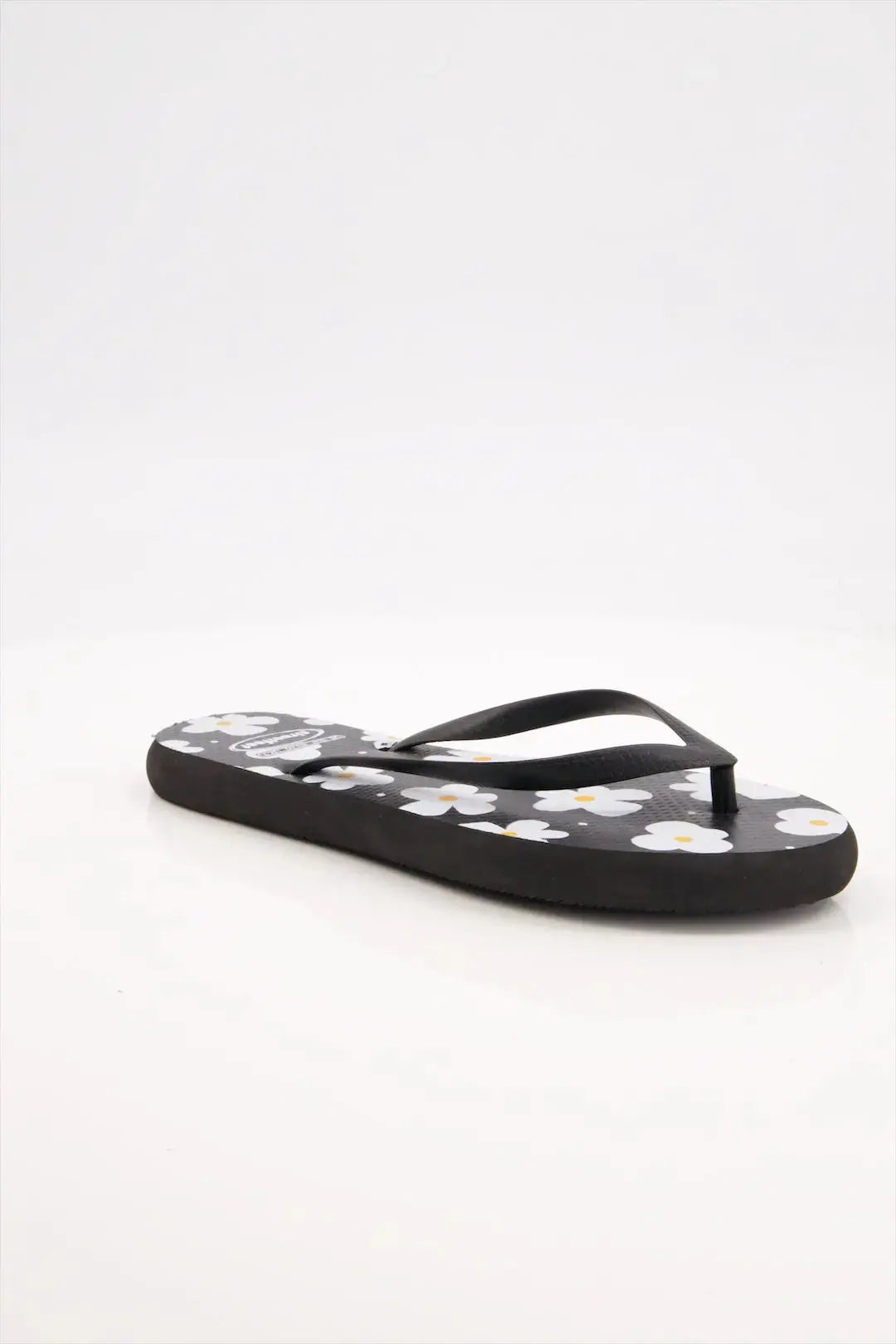 Street Feet's Flower Design Flip-Flops in black sole and white flowers, featuring soft soles and durable rubber straps for maximum comfort. Lightweight and breathable, ideal for casual wear.