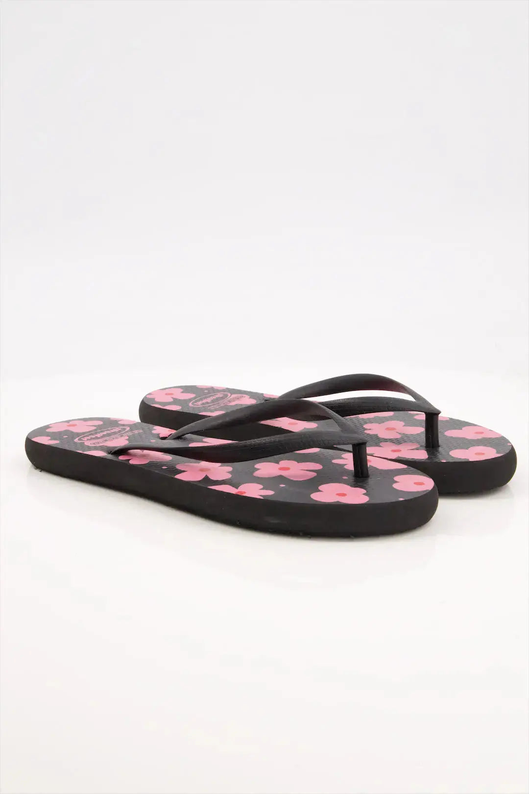 Street Feet's Flower Design Flip-Flops in black sole and pink flowers, featuring soft soles and durable rubber straps for maximum comfort. Lightweight and breathable, ideal for casual wear.