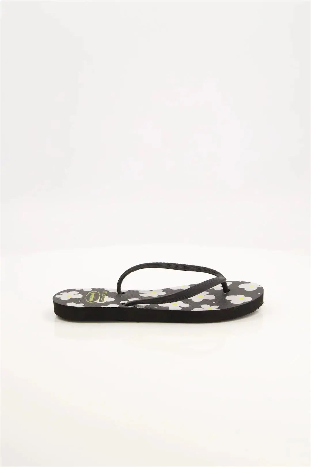 Street Feet's Flower Design Flip-Flops in black sole and white flowers, featuring soft soles and durable rubber straps for maximum comfort. Lightweight and breathable, ideal for casual wear.