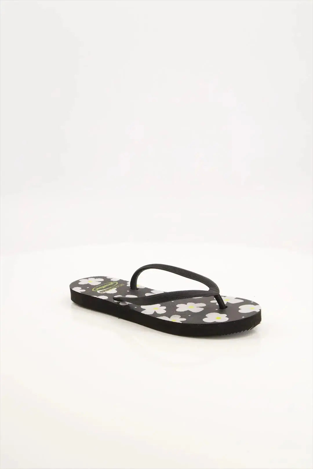 Street Feet's Flower Design Flip-Flops in black sole and white flowers, featuring soft soles and durable rubber straps for maximum comfort. Lightweight and breathable, ideal for casual wear.