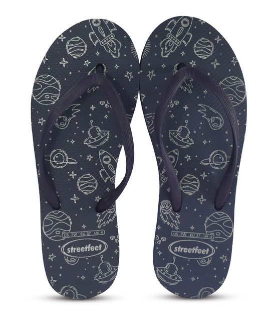 Women’s flip flops with space-themed silver print of planets and rockets on a blue base from Streetfeet

