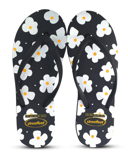 Street Feet's Flower Design Flip-Flops in black sole and white flowers, featuring soft soles and durable rubber straps for maximum comfort. Lightweight and breathable, ideal for casual wear.