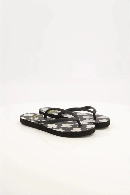 Street Feet's Flower Design Flip-Flops in black sole and white flowers, featuring soft soles and durable rubber straps for maximum comfort. Lightweight and breathable, ideal for casual wear.