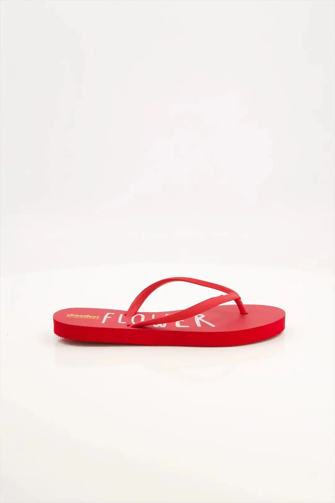 Flower Flip Flops by StreetFeet – An elegant and comfortable red footwear option with a delicate floral design, cushioned footbed, and a durable set of straps. A perfect addition to your wardrobe for a fresh and feminine look.