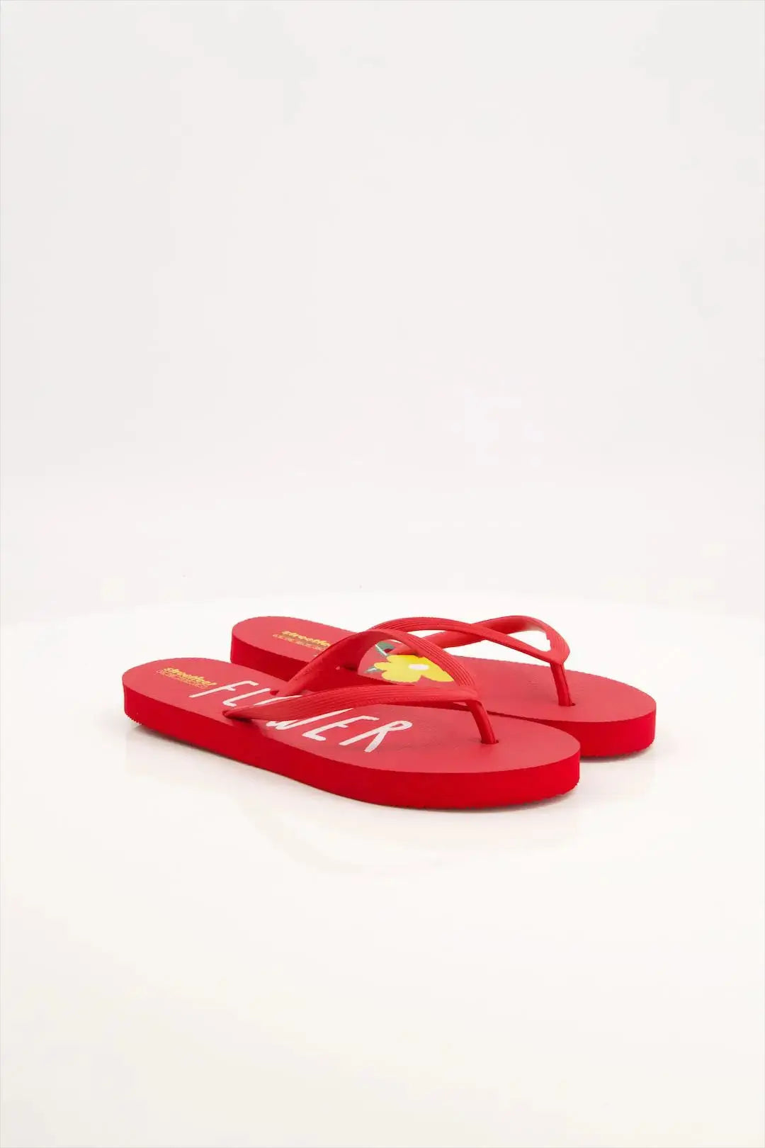 Flower Flip Flops by StreetFeet – An elegant and comfortable red footwear option with a delicate floral design, cushioned footbed, and a durable set of straps. A perfect addition to your wardrobe for a fresh and feminine look.